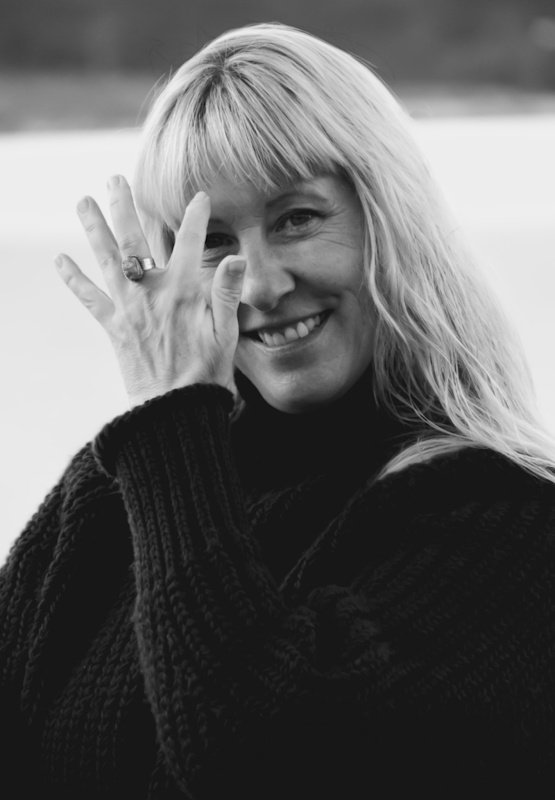 Svartvitt porträtt av kvinna med blomma, fotograferat av Sofia Borg Fotografi Uddevalla med naturligt ljus och mjuk ton.